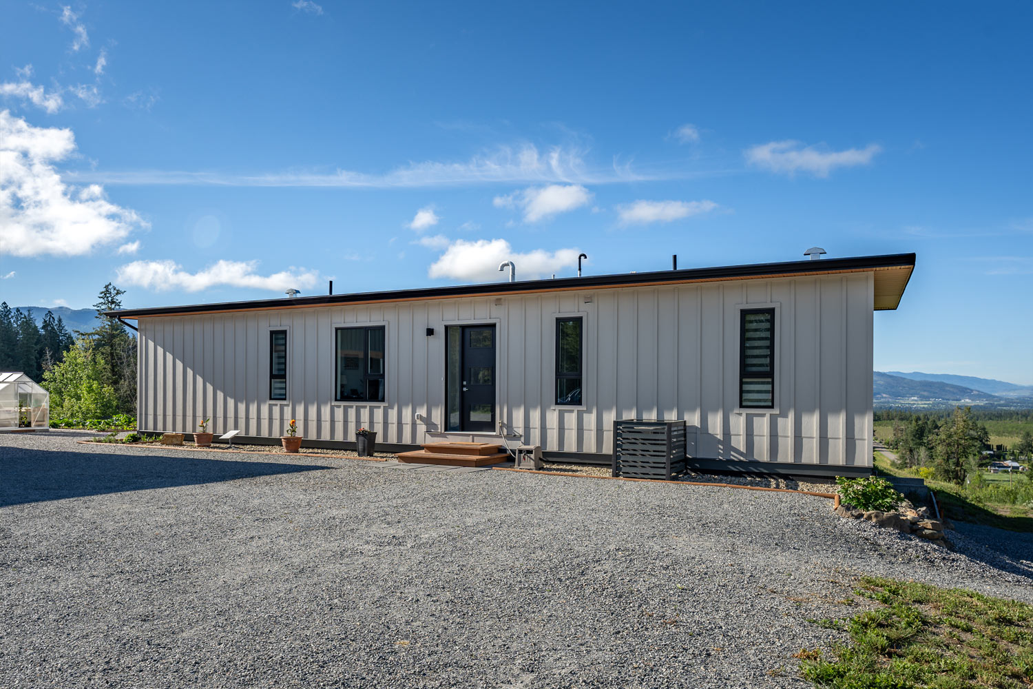 Chaparral building a modular home in Amstrong. This photos is an exterior shot of the building with beautiful modern white siding, and is a one story building,